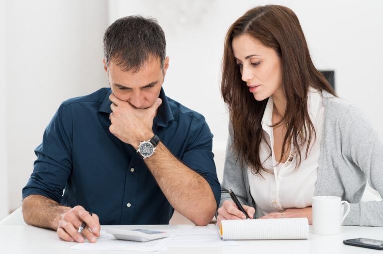 Man and a woman doing calculations